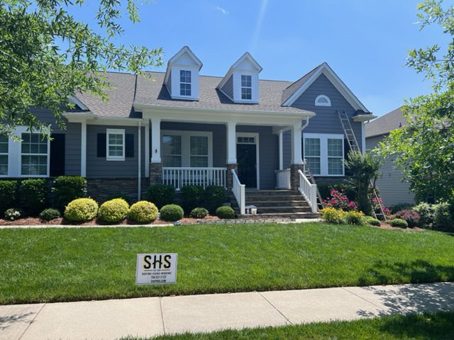 Southern Home Services crew installing new asphalt shingles on a Charlotte-area roof