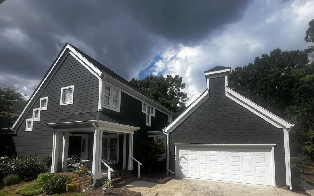 House with new Iron Gray James Hardie Siding and Arctic White Gutters plus downspout