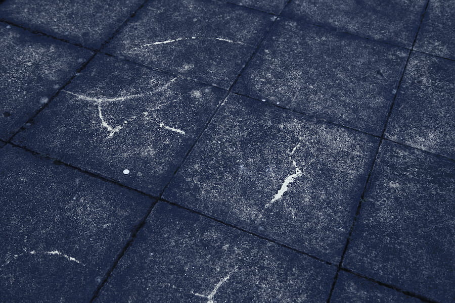 Dark black streaks running down asphalt shingles on a residential roof