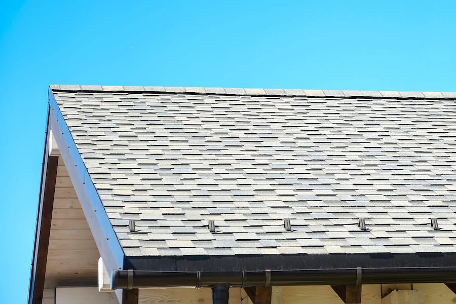 - Clean asphalt shingle roof after treatment for dark algae staining
