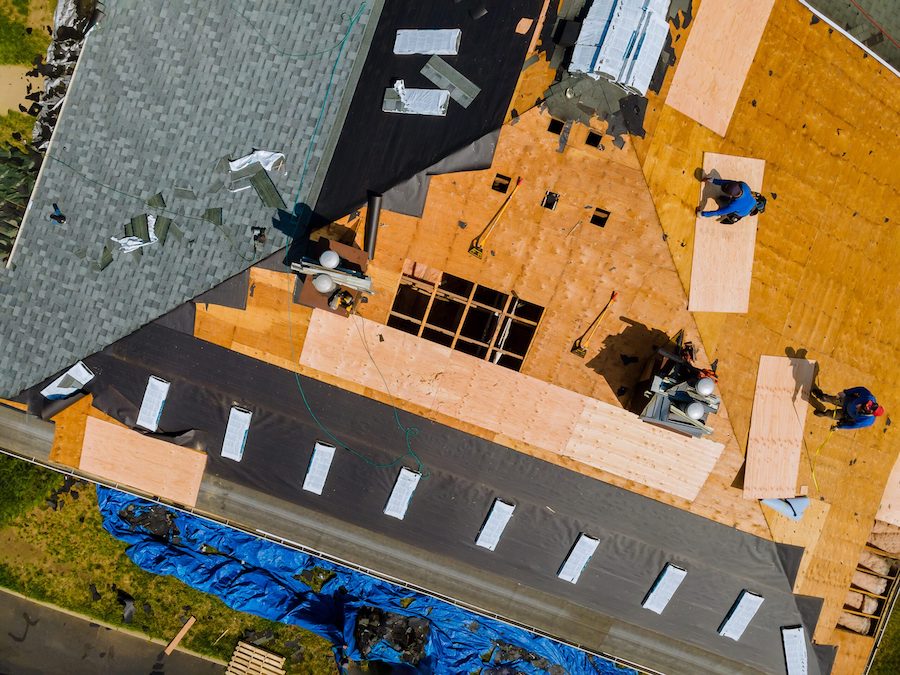 New underlayment being installed before asphalt roof shingles
